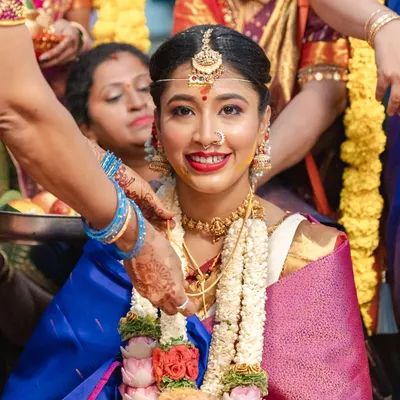 I believe a bride's true radiance shines through in the quiet moments. Here, amidst the beautiful chaos of a traditional Kannada wedding, her joyful smile says everything.
