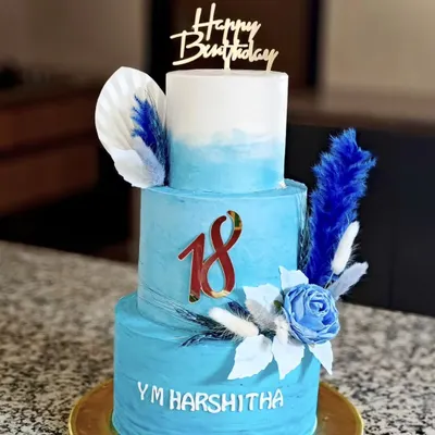 Welcoming adulthood with a tall, three-tiered vanilla cake for an 18th birthday. The blue ombre design is accented with dried botanicals and a sugar rose, filled with alternating layers of my homemade strawberry and blueberry compote.