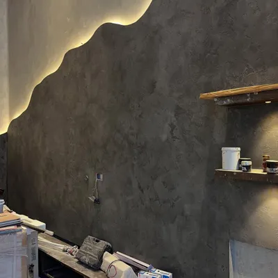 This is more than just a wall; it's a piece of art. We created this organic, flowing wave design with integrated LED backlighting in a micro-concrete finish, turning a simple surface into a dramatic focal point.