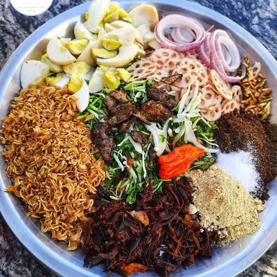 This is how I prepare my authentic Manipuri 'Singju'. It's a spicy salad with a mix of fresh vegetables, crispy noodles, boiled eggs, and roasted powders.