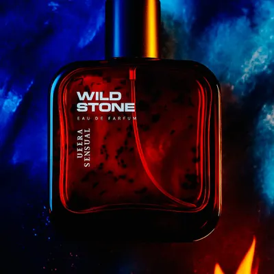A closer look at the Wild Stone Ultra Sensual perfume shoot. This shot focuses on the bottle's details against a dramatic, textured background of red and blue light, creating a powerful and masculine feel for the fragrance.