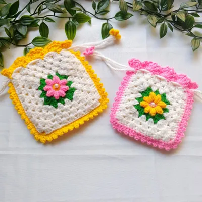 These are my floral granny square pouches, shown here in yellow and pink variations. They make wonderful, thoughtful return gifts for pujas, haldi-kumkum functions, or other small gatherings.