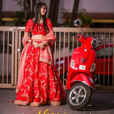A modern bride with a twist. This playful and unique concept pairs a traditional red lehenga with a vintage red Vespa, creating a fun, memorable, and stylish bridal portrait.