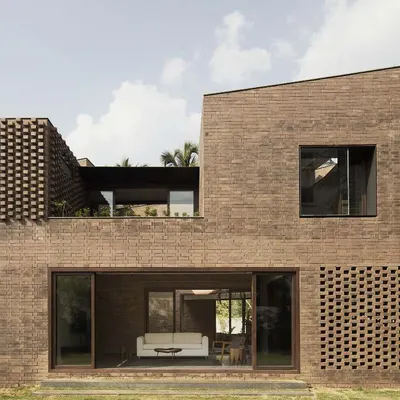 Our first house, a fully load-bearing brick construction in Bangalore. We embraced the challenge of this technique to create a home with rich texture and a monolithic presence, featuring brick jaali screens for natural ventilation.