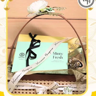 This Diwali hamper, a collaboration with skincare brand Brillare, is presented in a beautiful cane basket. It features their "Minty Fresh" product, elegantly tied with a custom branded ribbon from Winsome Hampers.