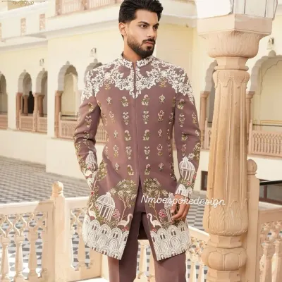 A unique sherwani in a muted mauve tone, featuring intricate white embroidery depicting a story with bird cages and floral motifs. This is a perfect example of how I can turn a personal vision into a wearable masterpiece.