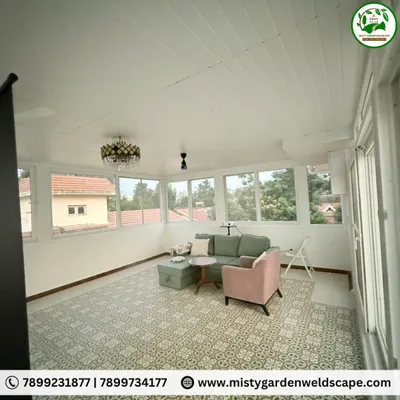 The interior of a completed terrace room, showing how the space is filled with natural light from large windows, creating a bright and airy living area with views of the neighborhood.