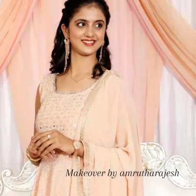 A soft and dreamy look for a reception. I styled her hair in gentle curls and used a peachy, monochromatic makeup palette to complement her beautiful pastel sharara.