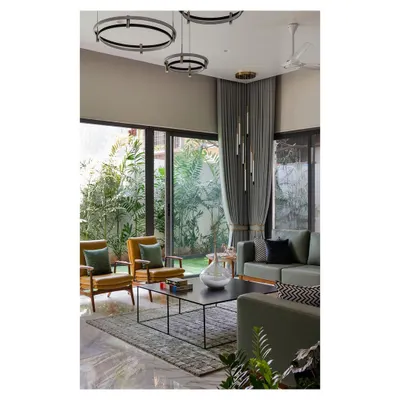 The living areas in the 'Solid Void Solid' house are designed as open, fluid spaces that connect directly to surrounding gardens. We used large glass panels and a neutral color palette to enhance the sense of spaciousness and draw the verdant landscape into the home's interior.