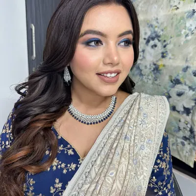For this client's meet and greet event, we went for a bold blue smokey eye. It's a fantastic way to add a pop of color and drama, especially when paired with a classic saree.