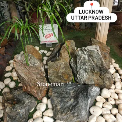 A beautiful arrangement of our natural stone boulders surrounded by contrasting white pebbles. This is the foundation of a classic Zen garden, creating a space of peace and contemplation for a client in Lucknow.