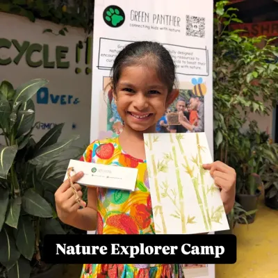 A happy explorer proudly showing off her bamboo painting and nature journal from our camp. Her smile says everything about the joy of creating with nature.