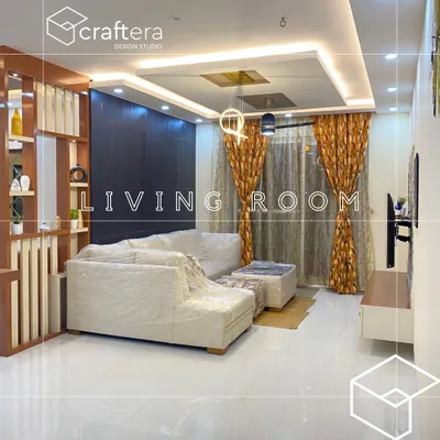 A living room just before handover, with the sofa still wrapped for protection. I used a wooden partition to create a subtle separation of space and designed a false ceiling with layered lighting to add warmth and character.