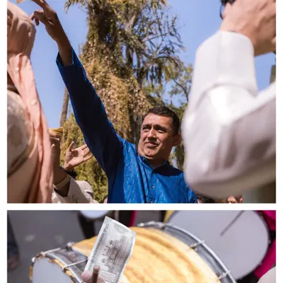 The energy of the Baraat. A guest joyfully throws money in the air, a traditional part of the celebration, while the dhol player keeps the beat.