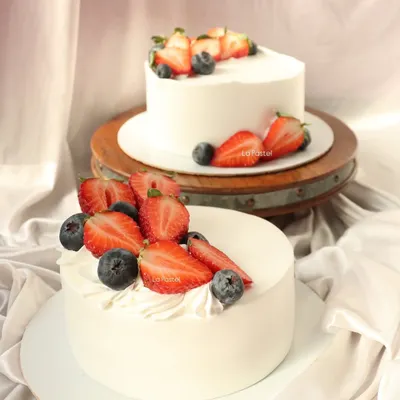 My classic fresh fruit cakes. These eggless vanilla cakes are topped with fresh strawberries and blueberries for a simple, elegant dessert.