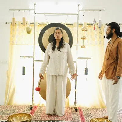 A student experiences a gong bath, a powerful technique for deep vibrational healing.