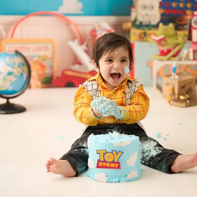 A "Toy Story" themed cake smash for a little fan. We love incorporating your child's favorite characters and stories into our first birthday photography sessions.