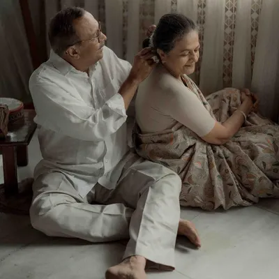 A simple, tender gesture of him placing a flower in her hair. It’s in these quiet moments that a lifetime of love speaks the loudest. This is the kind of authentic connection I strive to capture.