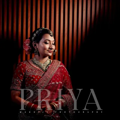 I love using creative lighting to make my bridal portraits stand out. Here, the dramatic shadows and warm light create a serene and elegant portrait of the bride, Priya.