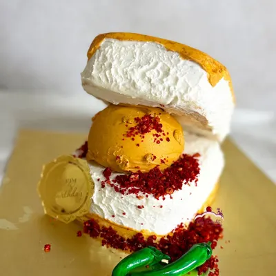 A cake for a true Mumbaikar! This is a Vada Pav cake, complete with the "vada" (a cake ball), "chutney" (colored crumbs), and even sugar-paste chillies. It was a butterscotch praline cake inside.