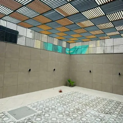 This unique project features a custom-designed louvered ceiling with a multi-color checkerboard pattern. It's a perfect example of how a pergola can be a functional piece of art, controlling light and adding a dramatic visual element.