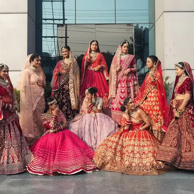 A beautiful showcase of our students' work on exam day. This group photo highlights the variety of bridal lehengas, makeup styles, and hair designs they mastered during their course, from vibrant reds to soft pinks.