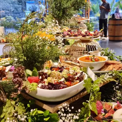 Our grazing table brings dips and little bites together among greenery, with serving stands giving the food different heights.