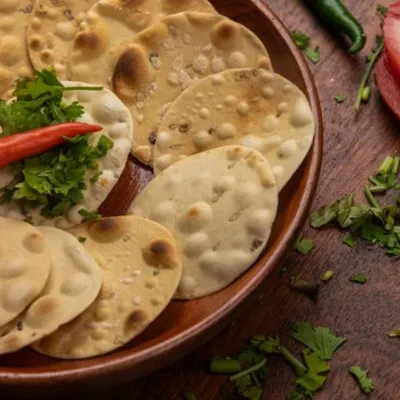 We create appetizing food flatlays using fresh ingredients and rustic styling. This image of Indian crackers is perfect for packaging, menus, or social media content, highlighting the product's texture and flavor profile.