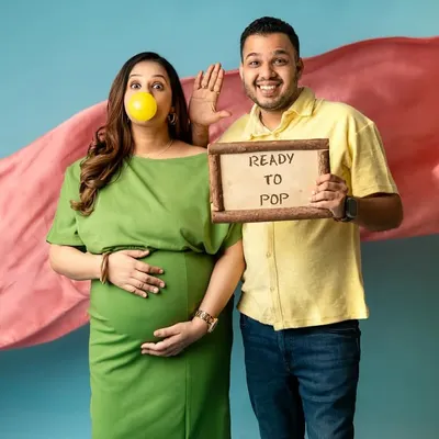 "Ready to Pop!" This is such a fun and playful concept for a maternity shoot. The bubblegum and the cute sign add a touch of humor and personality to their announcement photos.