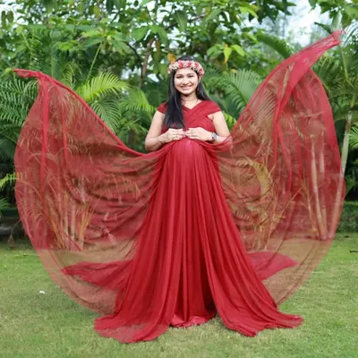 This wine-colored A-line gown features convertible straps that can be styled into beautiful, wing-like trails. It's a versatile and dramatic option for an outdoor photoshoot.