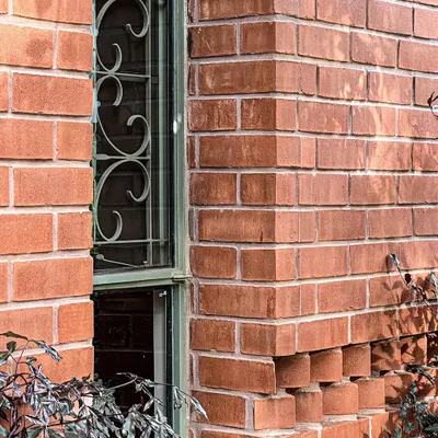 We often explore the sculptural possibilities of common materials. This detail from the Ferns Cottage shows a projecting brick pattern that creates intricate shadows and adds a unique texture to the facade.