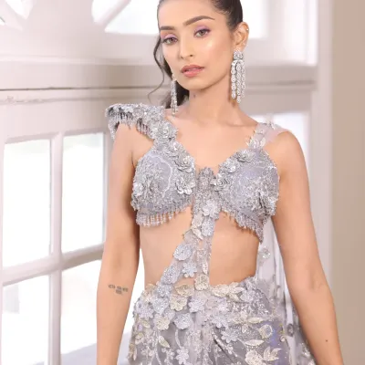 Creativity is key in makeup. This modern look with a unique silver-grey outfit and dramatic earrings is perfect for a fashion-forward client.