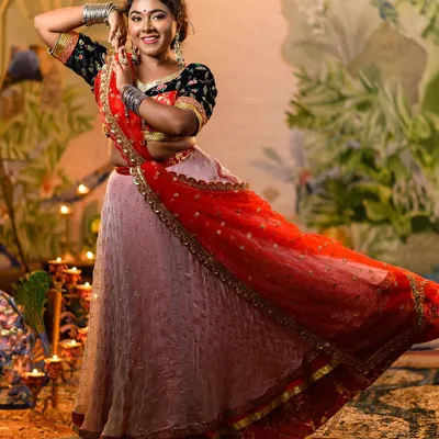 Our recreation of Deepika Padukone's iconic 'Ram Leela' lehenga, captured in a dynamic pose that shows the beautiful flare of the skirt. The red dupatta adds a striking contrast to the black embroidered choli.