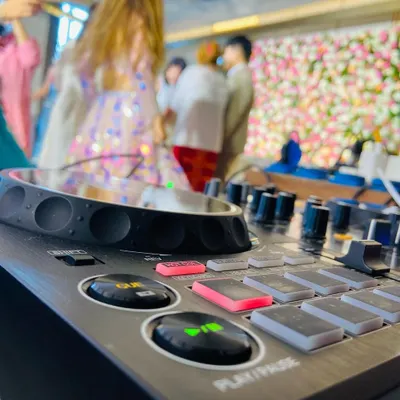 A close-up of my Pioneer DJ controller, the heart of my setup. The cue and play buttons are ready for action at a wedding party.