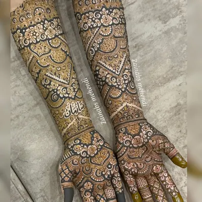 A complete view of the bridal henna for Tasmiya. The design extends beautifully up the arms, creating a cohesive and stunning look from every angle.