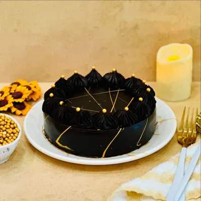 The Dutch Truffle cake is a timeless classic for a reason. This versatile cake, with its deep chocolate flavor and elegant finish, is perfect for any event. I decorate it with dark chocolate frosting and delicate gold accents for a touch of luxury.