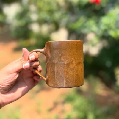 Our Languid Magic glaze is truly unpredictable. This faceted mug shows off the warm, wood-brown tones that can result from the firing.