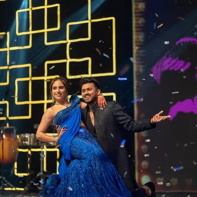 A Sangeet night is incomplete without an epic couple's performance. This shot, with confetti raining down, captures the energy and romance of their dance.