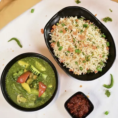 A perfect Indo-Chinese combo featuring our aromatic Burnt Garlic Fried Rice and vegetables in a vibrant green garlic sauce, served with a side of spicy chili paste.