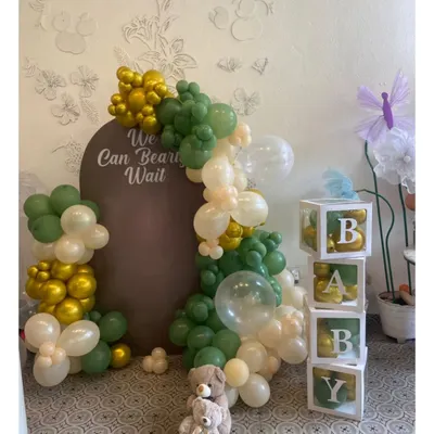 "We Can Bearly Wait" is a popular and adorable theme for a baby shower. This setup features a beautiful balloon garland and "BABY" blocks.