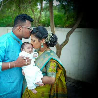 A tender moment between new parents and their baby. Kisses from mom and dad make for the most precious family portraits.