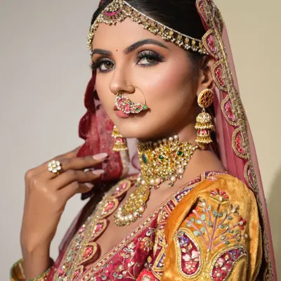 A close-up from a styled bridal shoot, showcasing a dramatic and regal look. The smokey eye, flawless contour, and intricate jewelry come together to create a breathtaking vision of bridal beauty.
