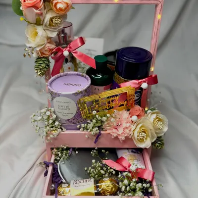This drawer-style hamper is a perfect gift for her. The top holds a beautiful arrangement of self-care products, while the bottom drawer pulls out to reveal a secret stash of chocolates.