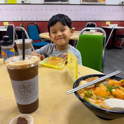 My son Zev enjoying a snack at a kopitiam in Kuala Lumpur. His happy smile is everything. These are the simple, cherished moments and food memories I hope he carries with him forever.