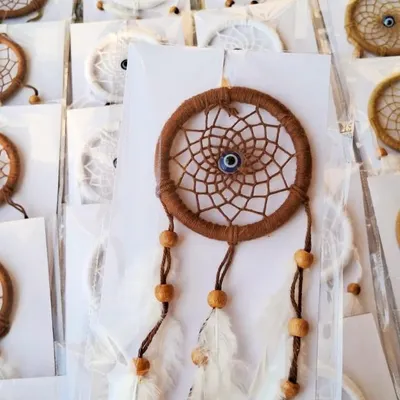 I made a bulk order of 50 of these mini dreamcatchers for a client's birthday party favors. They are available in white or brown and feature an evil eye bead for protection.