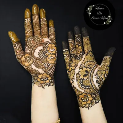 A beautiful example of my floral work, featuring a large central flower on the back of the hand, surrounded by delicate leaves and paisleys. The shading adds incredible depth.