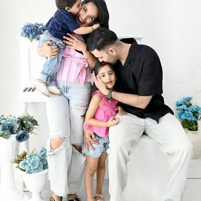 A candid moment of pure family love. The hugs, the kisses, the laughter, these are the unposed shots that truly tell your family's story during a milestone photoshoot.