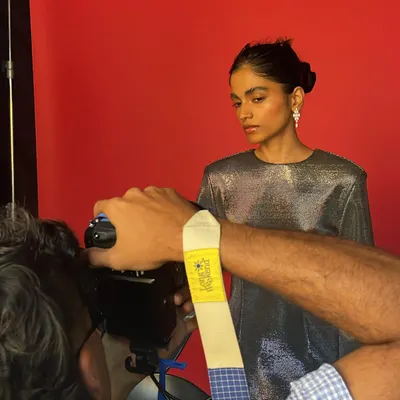 A behind-the-scenes moment from a jewelry shoot. This shows the collaboration between myself, the photographer, and the model to get the perfect shot against a vibrant red backdrop.