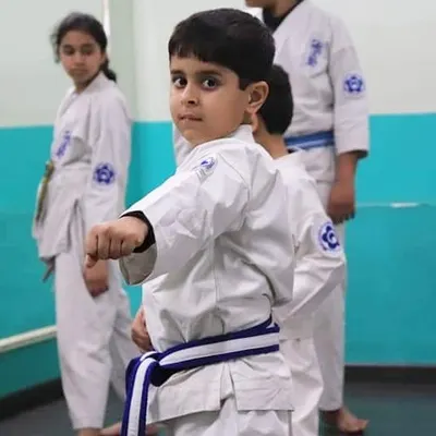 We teach our youngest students that true strength begins with focus. This young karateka demonstrates the concentration and discipline we instill in our kids' karate classes.