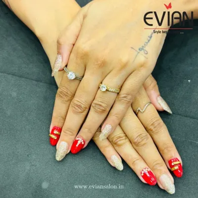 A detailed look at this festive nail set. You can see the texture of the full-coverage gold glitter nails next to the smooth red polish, accented with tiny rhinestones for extra sparkle.